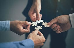 People holding puzzle pieces