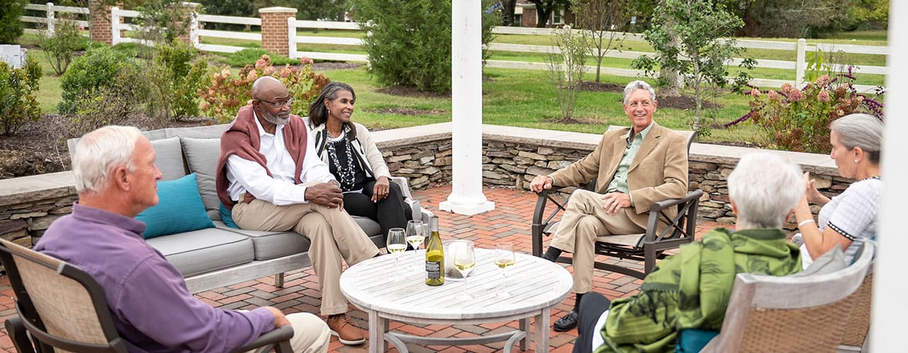 Friends gathered outside for glass of wine.